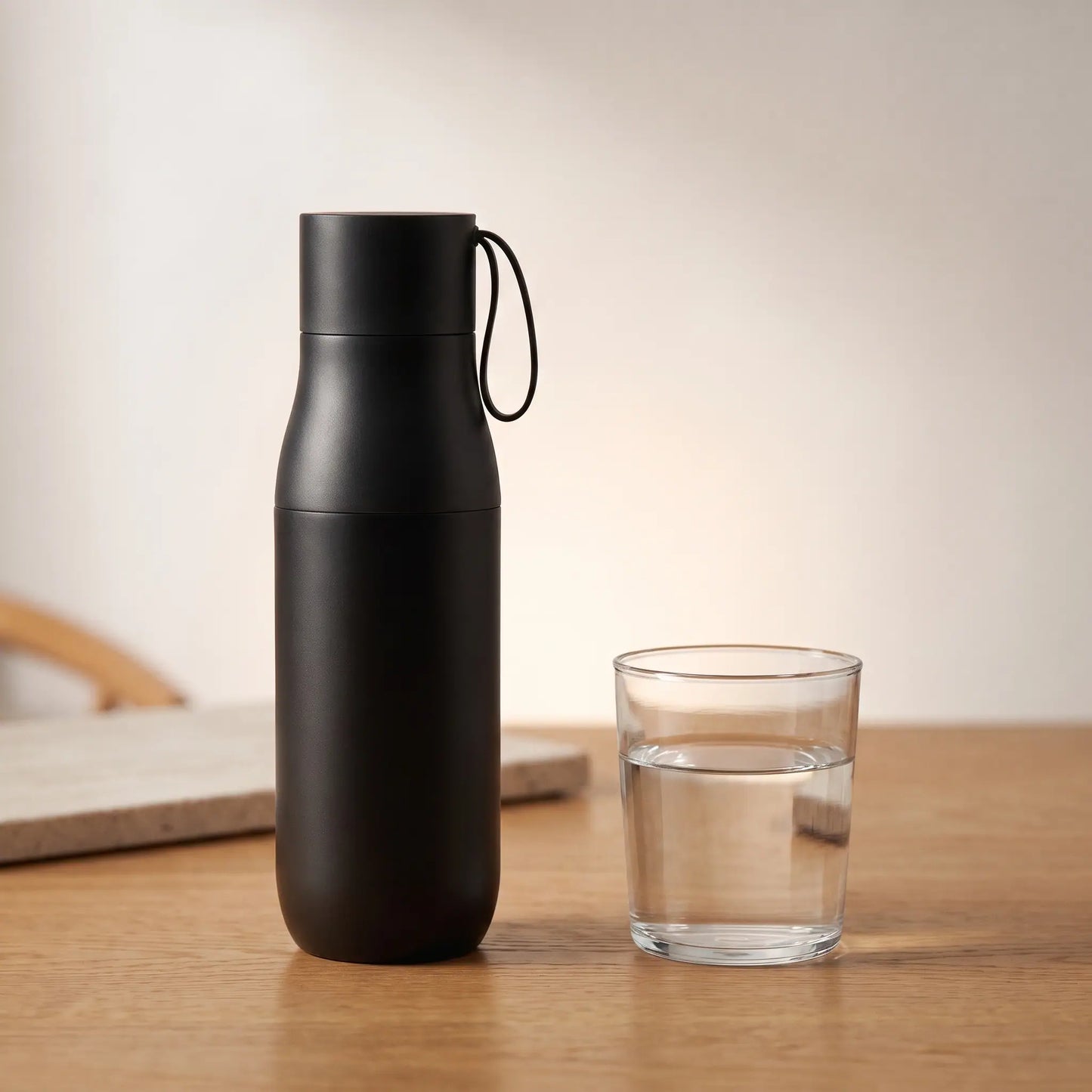 The Ritual Bottle beside a glass of water