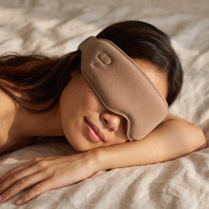 The Unwind heated eye massager in Earth