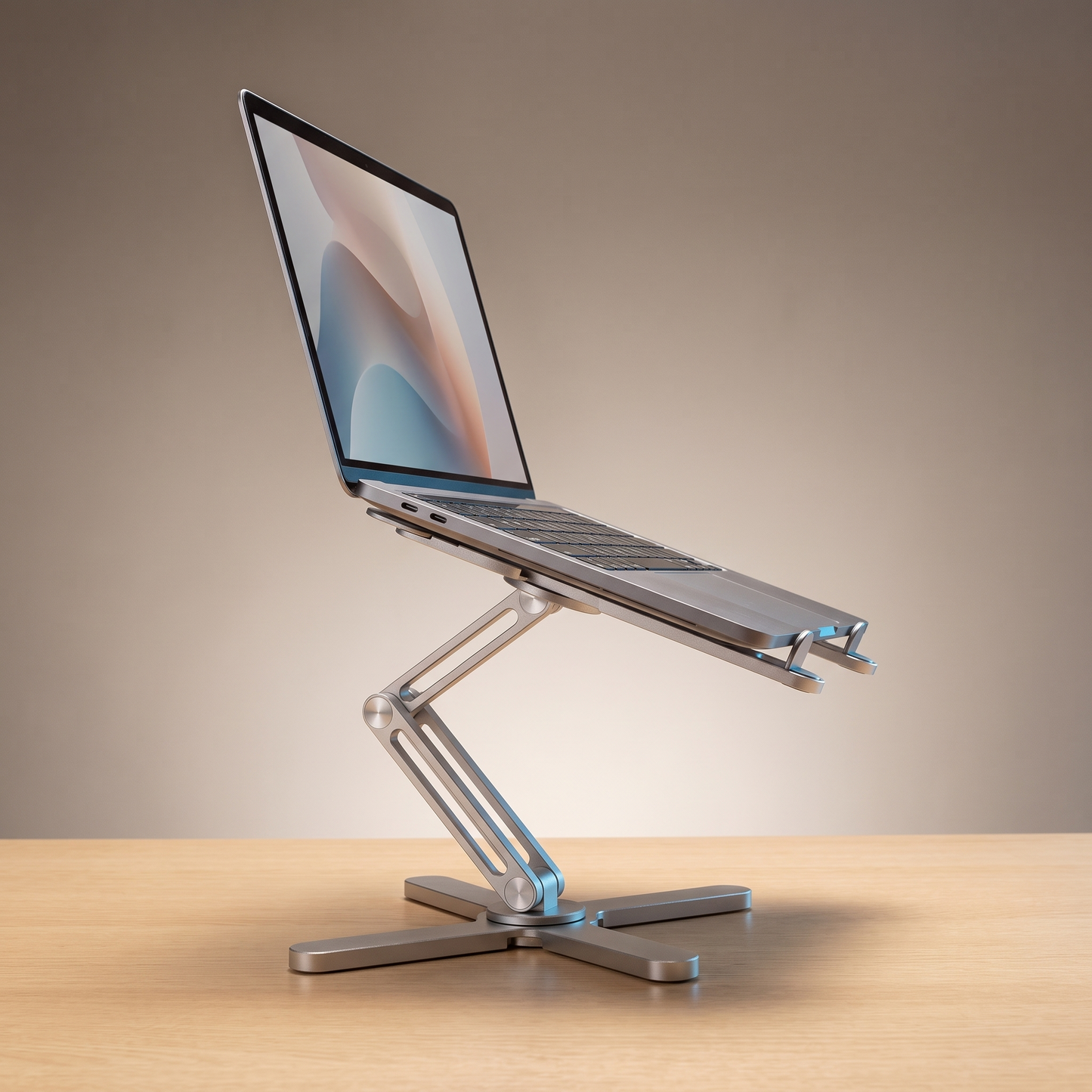 The Pivot laptop riser in Brushed Silver, holding a laptop at eye level