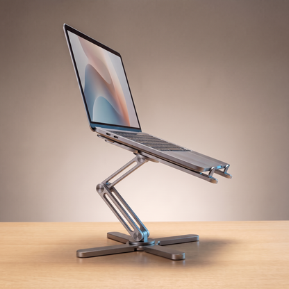 The Pivot laptop riser in Space Grey, holding a laptop at eye level